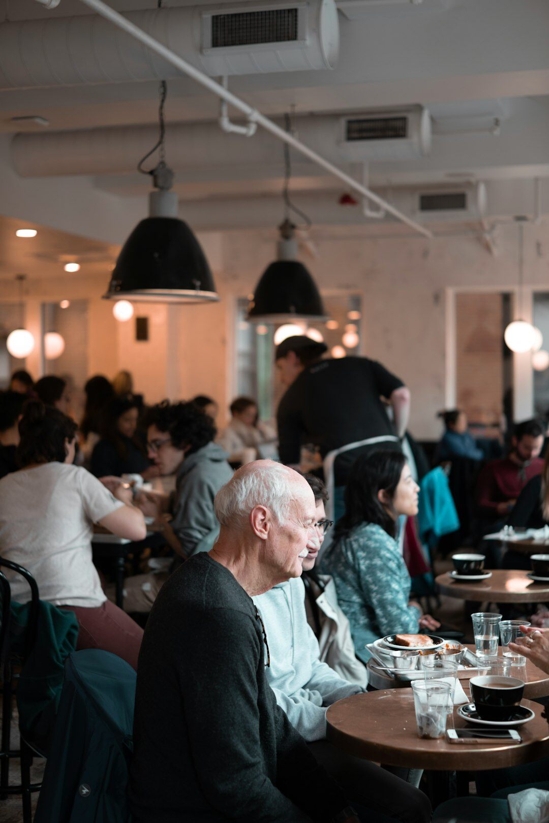 Senior citizens chatting over coffee at a table