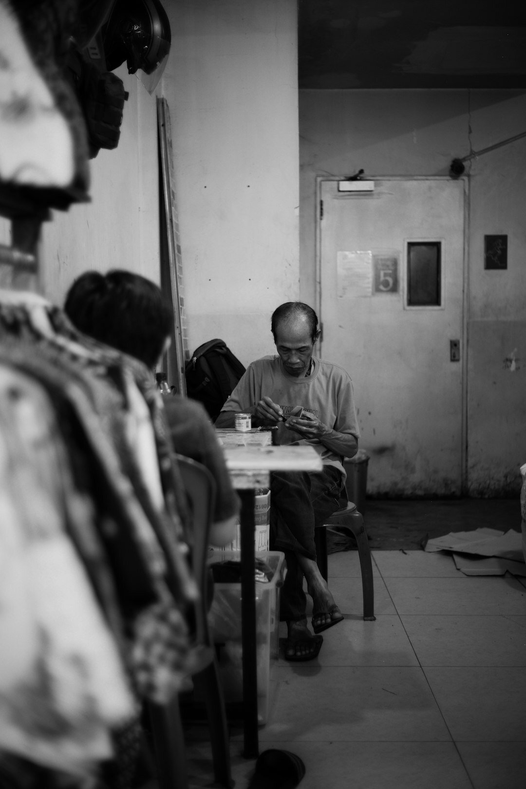 Senior citizens doing a handicraft workshop indoors at a table